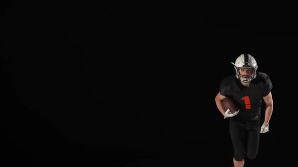 American Football Player Running Across Field with Ball and Being Attacked By an Rival Against Black alt