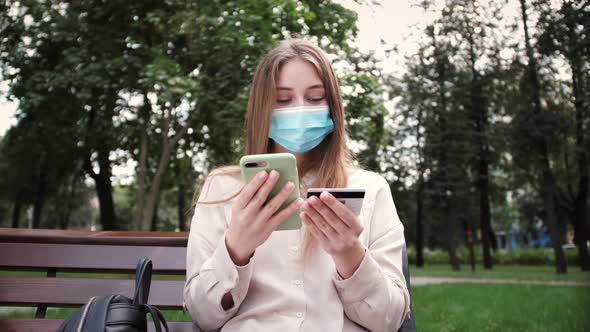 Smiling woman shopping online using smartphone paying with credit card, buy remotely. alt