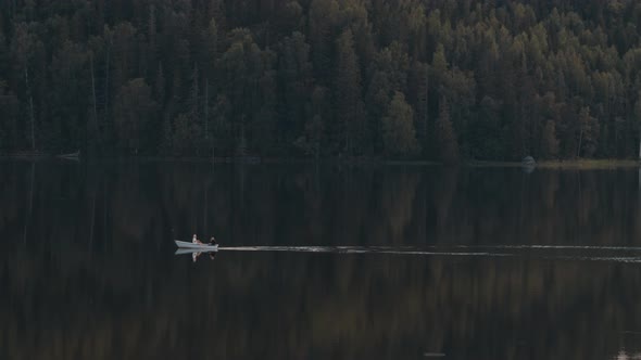 Rowboat on a dark reflective lake