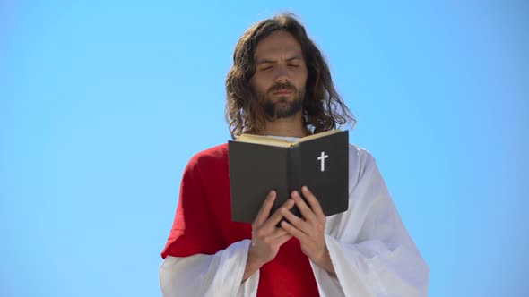 Priest in Robe Reading Holy Bible, Closing Eyes to Pray, Christian Theology alt