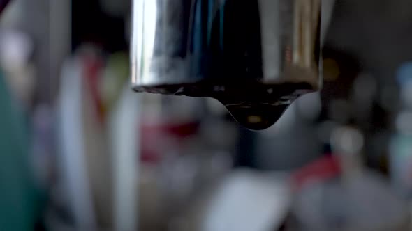 A leaky tap: water gathers on the tap's edge and forms a drop, then falls down. alt