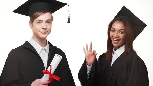 African American Young Graduate Female in Black Robe and Square Academical Cap Showing Ok While Her alt