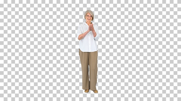 Smiling applauding old woman in glasses, Alpha Channel alt