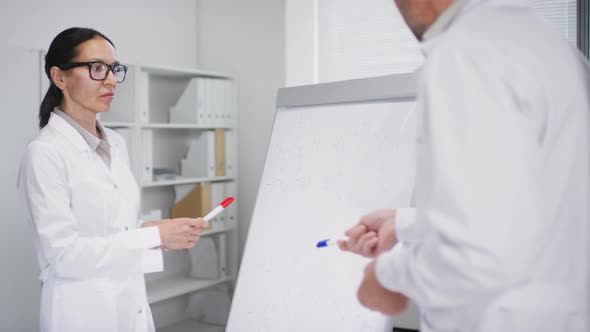 Biomedical Scientists Discussing Work in Laboratory alt