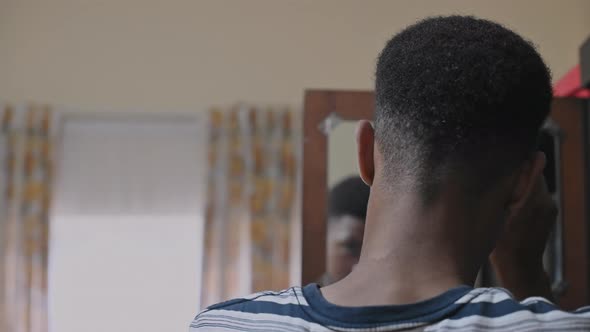 Rear View of Teenager Using a Afro Comb