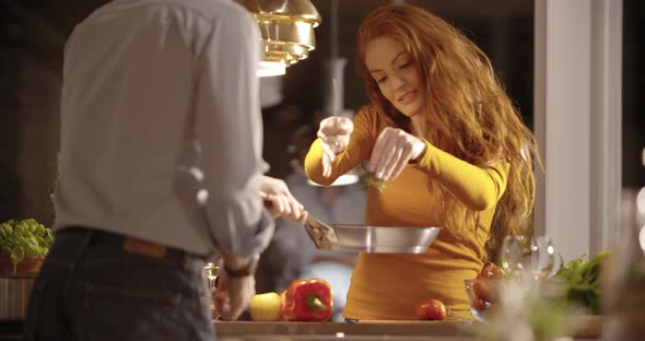 Woman Prepare Dinner at Home While Man Drink Wine