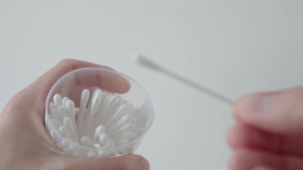 Man's Hand Takes a Cotton Swab From a Plastic Box