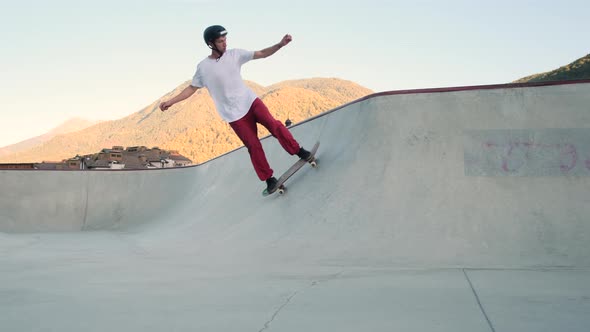 Skateboard Rider Sharpening His Skills in Bowl Ramp alt