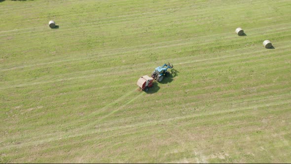 Blue Tractor Hay Bales Field Aerial View