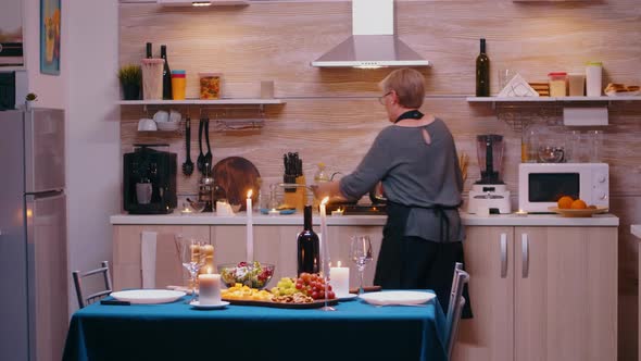 Elderly Woman Cooking for Husband alt