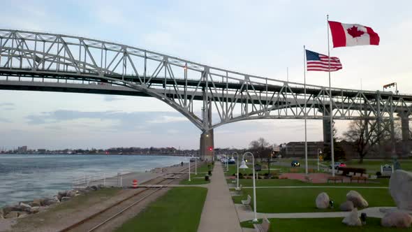 Bluewater Bridge connecting Port Huron, Michigan USA and Sarnia, Ontario Canada with flags waving. alt