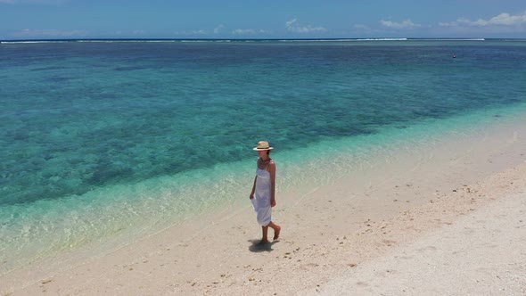 Girl Walking on a White Sand Beach on a Tropical Island in the Mauritius Indian Ocean alt