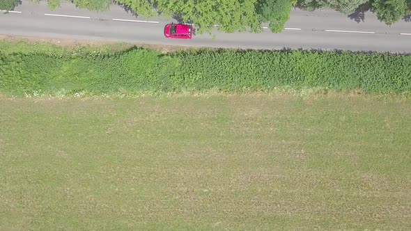Aerial overhead view of cars driving along a rural road in Devon, England, STATIC CROP alt
