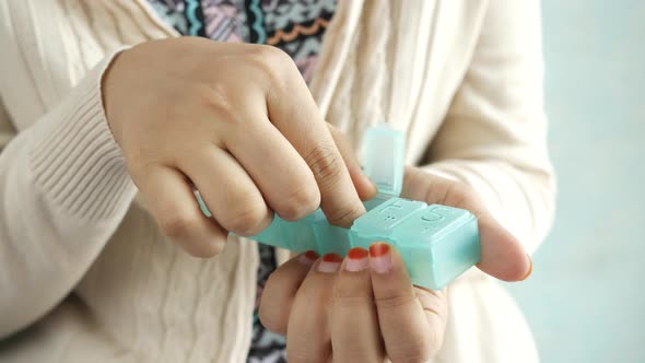 Women Hands Taking Medicine From a Pill Box alt