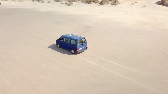 Aerial view of van driving on the beach of borsmose in Denmark