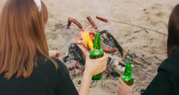 Young Teen Woman Happy Friends Camping in Nature Having Fun Together Drinking Beer and Clinking alt