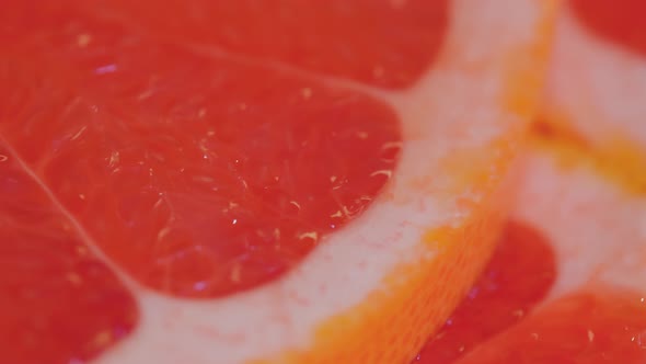 Fresh Citrus Fruit Slices of Grapefruit on Rotating Surface  Close Up Macro