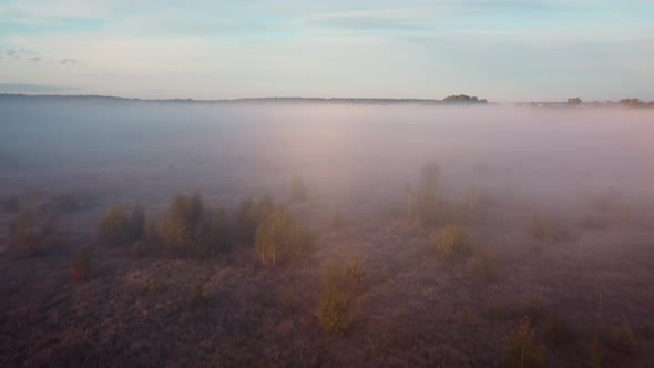 Aerial footage of going down into thick fog in the valley