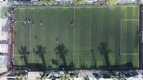 Top View of a Drone Taking Aerial Shots of Kids Playing Soccer on a Soccer Field alt