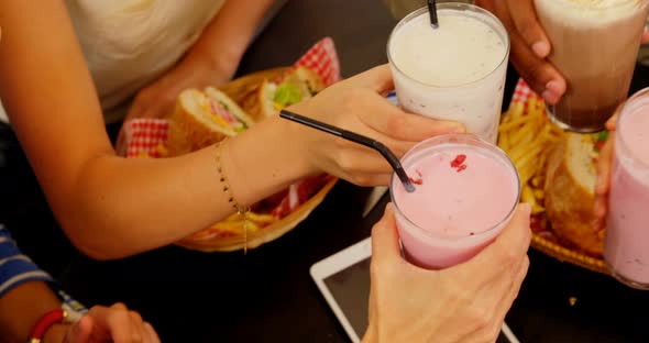 Mid section of executives toasting milkshake 4k alt