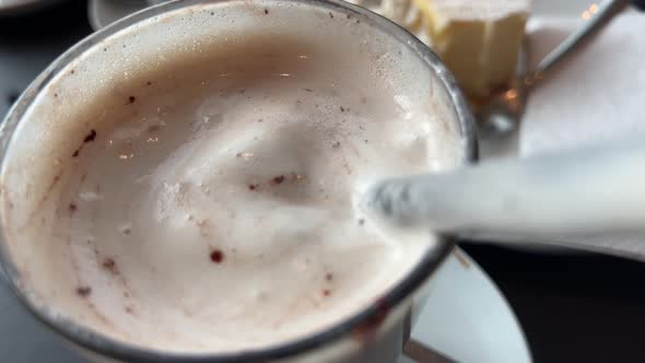 Drinking hot chocolate with cream through a straw alt
