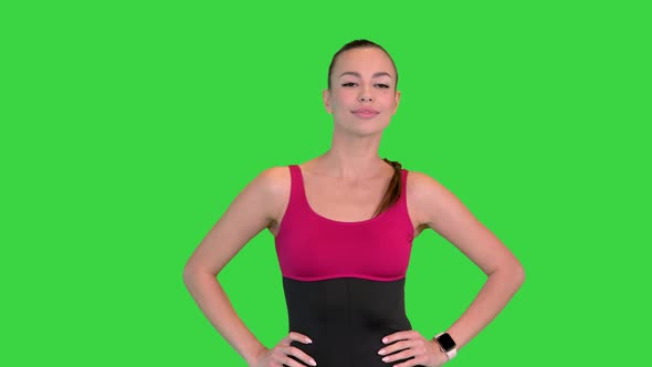 Caucasian Woman Athlete Wearing Black Sportsbra Warming Up Neck Before Workout on a Green Screen