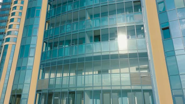Aerial Exterior of Highrise Multistory Building Windows Reflects Sky
