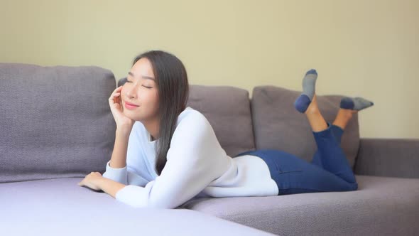 Asian woman sit on sofa and relax