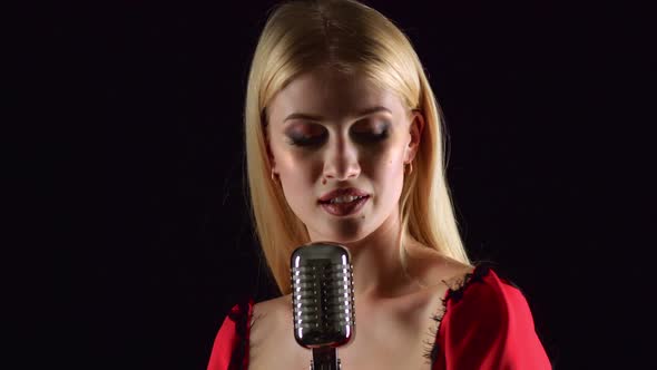 Girl in Singing in Retro Microphone Hilarious Song, Black Background alt