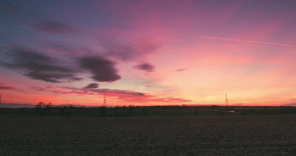 Wispy Clouds Over Field At Sunset Time Lapse With Pylons