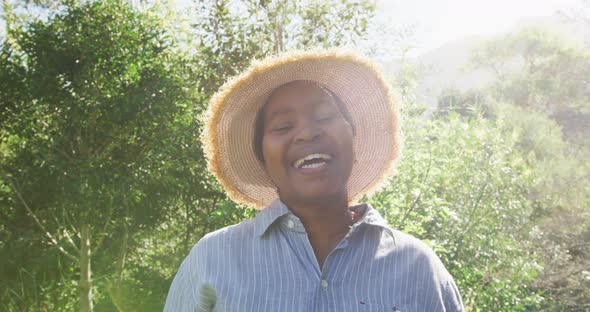 Happy african american senior woman looking at camera outdoors alt