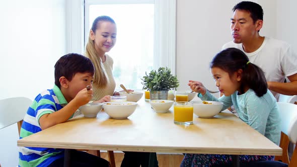 Happy family having breakfast alt