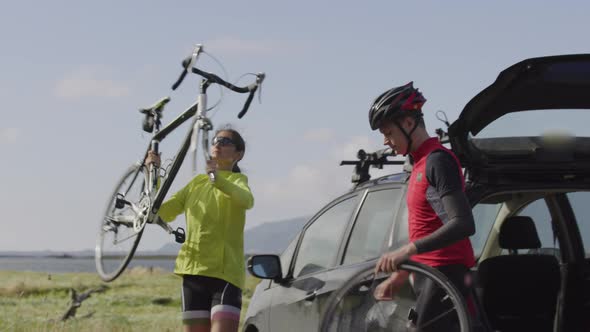 Cyclists preparing bicycle for ride.  Fully released for commercial use.