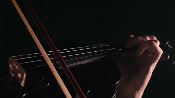 Hands of a Musician Playing the Violin Close-up with Beautiful Lighting alt