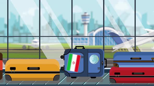 Suitcases with Iranian Flag Stickers on Baggage Carousel alt
