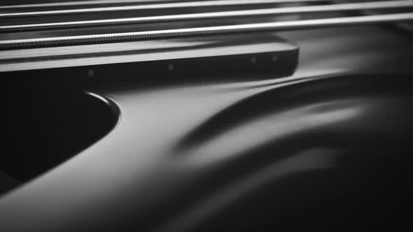 Neck and body of a fretless electric bass guitar on the dark background alt