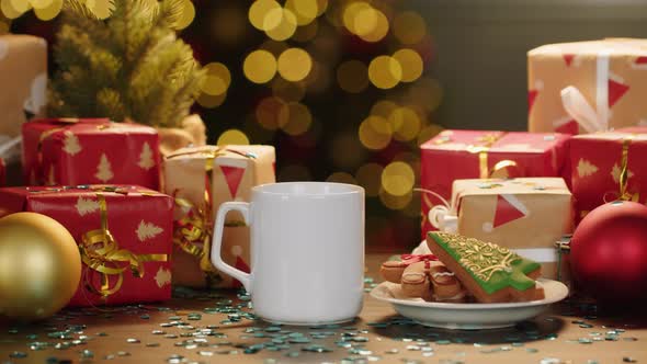 Hot Drink and Cookies on Table with Christmas Gifts and Decorations