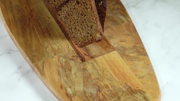 Slices of Rye Bread Fall on the Cutting Board