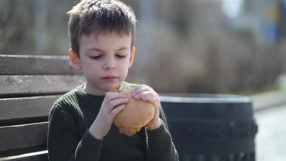 Hungry Kid Eating Burger Outdoor