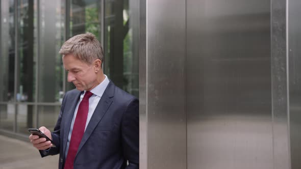 Businessman on way to a meeting checking his smart phone