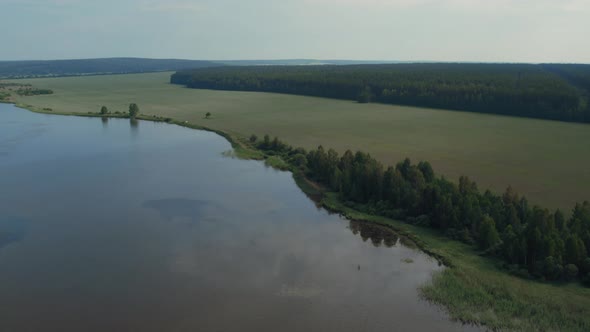 Lake and green fields in Ural