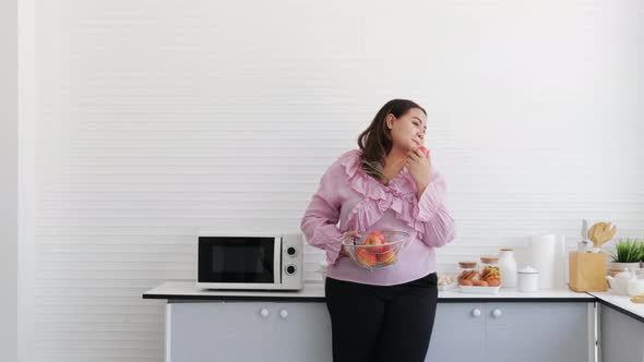 Overweight young woman with healthy fruit and diet food and low-calorie fruit concept