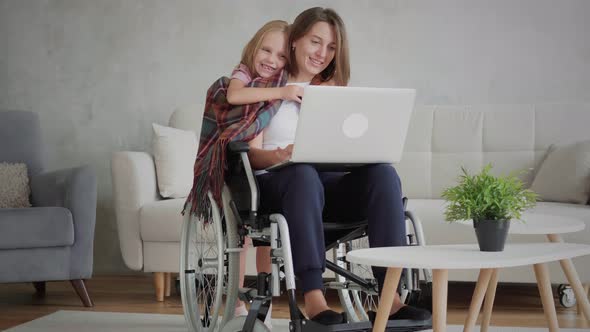 Disabled woman with her daughter alt