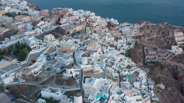 Aerial shot of famous Oia village in Santorini at sunrise in Greece.