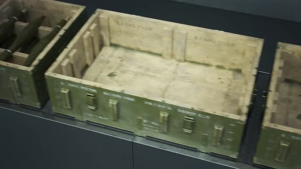 Robot packing military boxes with RPG missiles. Packing line. Loopable. 4KHD alt