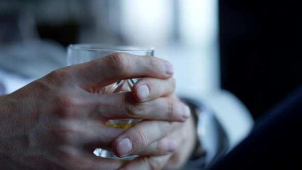 Gentleman Hands Drinking Whiskey in Restaurant Closeup alt
