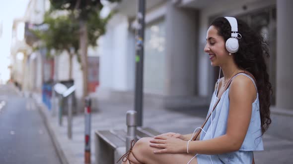 Young Teenage Girl Having Fun Listening To Music in City