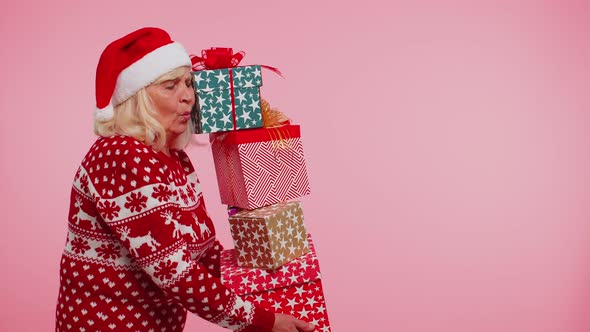 Senior Grandmother Woman in Christmas Sweater Holding Many Gift Boxes New Year Present Shopping Sale alt