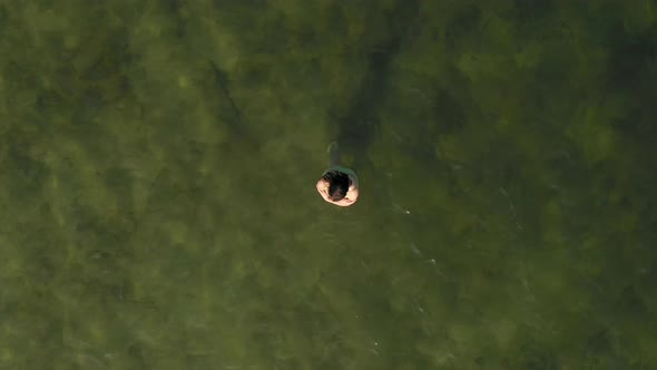 Woman wading in shallow water, Breda, Noord Brabant, Netherlands