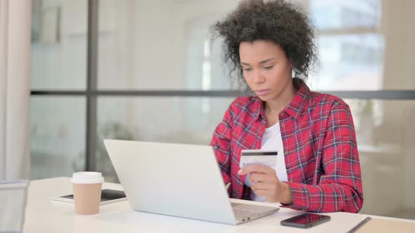African Woman Making Successful Online Payment on Laptop alt
